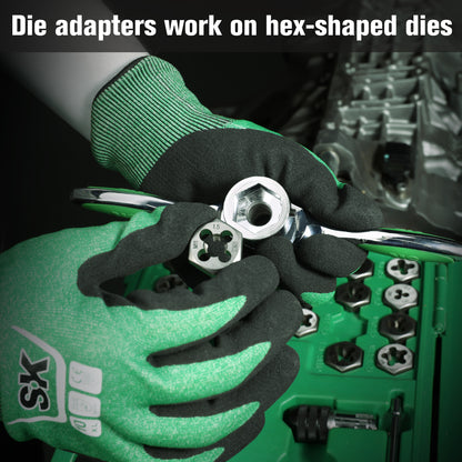 Person wearing green gloves holding a die adapter with hex-shaped dies.